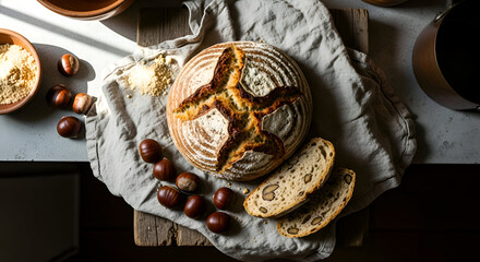 Freshly baked artisan bread with chestnuts and walnuts on a rustic wooden surface
