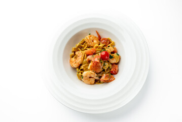 Tagliatelle pasta with shrimp, cherry tomatoes, and creamy sauce, garnished with herbs. Served in a white bowl. Close-up shot, vibrant colors, gourmet seafood dish.