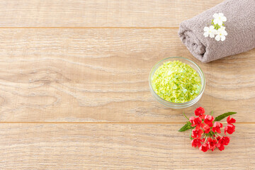 Body care products with a towel on the wooden background.