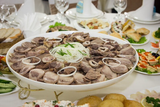 Traditional Kazakh dish beshbarmak with kazy, horse meat, and mutton on the festive table