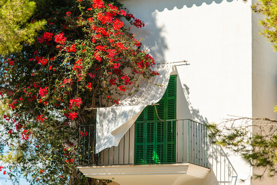 Traditional Spanish house with a balcony. Shuttered windows and balconies in Mallorca	
