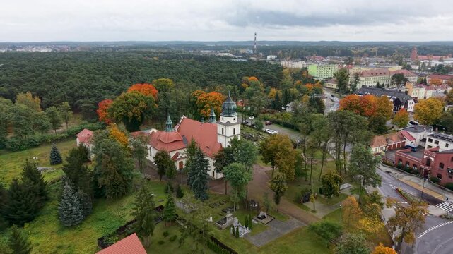 Aerial Solec Kujawski Poland parish church circle 1. Historic village city along Vistula River. Modern city based on historical Polish architecture. Apartment complex, school, sports fields and parks.