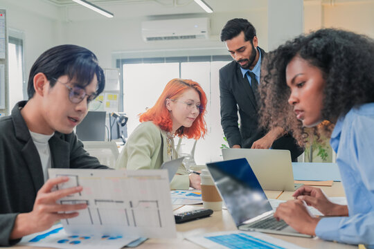 group of multicultural male and female professionals meet inside a contemporary office, leveraging artificial intelligence and big data analytics to brainstorm, exchange ideas, and build adaptive 