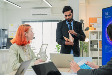 Multicultural business colleagues participate in an energetic office workshop, using artificial intelligence and data-driven insights to brainstorm innovative ideas, align creative strategies