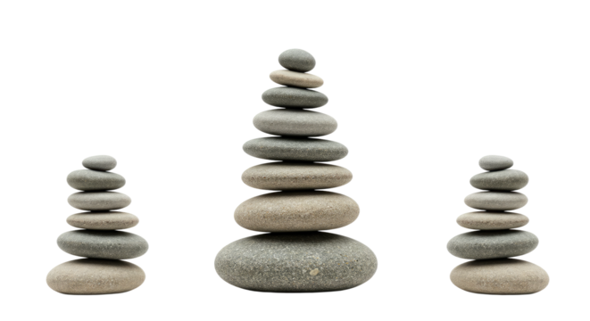 Stacked balancing stones arranged in three piles on a white background, symbolizing harmony and meditation, perfect for wellness and mindfulness themes