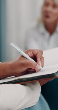 Therapy, hands and writing in notebook for consultation, patient notes and discussion in office. Person, psychologist or journal in practice for healthcare, mental health report or counseling service