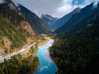 Aerial View of a Serene Mountain Valley with a Turquoise River and Lush Forests