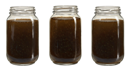 Three glass jars filled with dark brown homemade sauce or jam isolated on white background, perfect for food packaging or cooking blogs