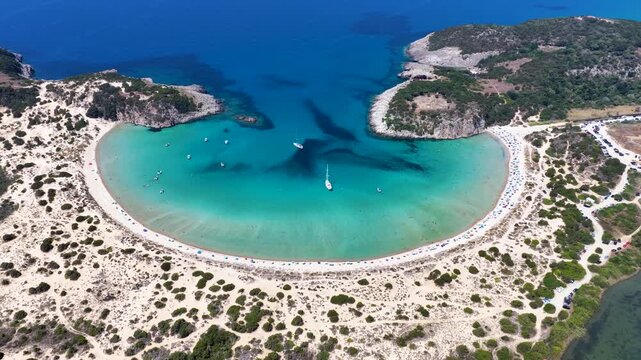 Establishing aerial view of the popular Voidokilia beach in Messinia, Peloponnese, Greece, with sand dunes and turquoise sea