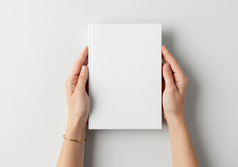 Elegant hands showcase a pristine white book cover, perfect for your custom design, branding, or manuscript presentation needs.