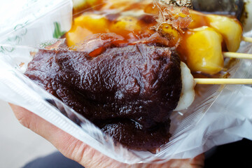 Traditional Japanese dango and mochi sweets in a takeaway container