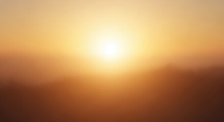 The sun shines brightly over a hazy landscape, casting a warm, golden glow.
