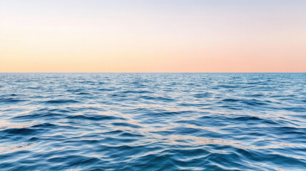 Obraz premium Calm blue ocean meets soft pink sky, creating dreamlike atmosphere of tranquility