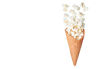 Creative composition of a waffle cone filled with popcorn spilling out, isolated on a transparent background