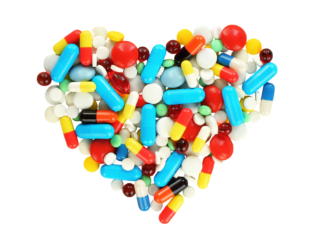 Medical tablets scattered in the shape of a heart, isolated on a transparent background
