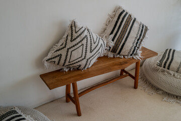 Wooden bench with knitted cushions
