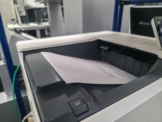 Printer in use at an office during work hours with a document being processed