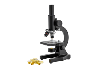 A black microscope with scattered yellow capsules, suggesting scientific research or analysis of supplements. background removed