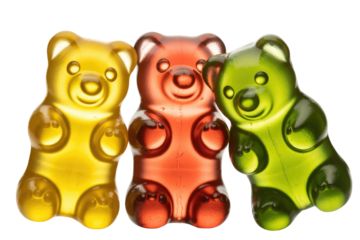 Three gummy bear candies in yellow, red, and green, arranged closely together. background removed
