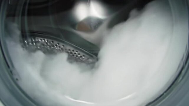 A swirling spectacle of soapy water inside a working washing machine ensuring clean laundry in a bright metallic