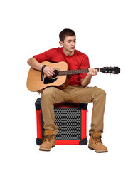 Man sitting  with a acoustic guitar in his hands.