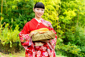Fototapeta premium 贈答品を手に持つ振袖姿の女性