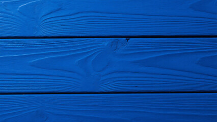Vibrant royal blue painted wooden planks offer a stunning textured background perfect for creative design projects and modern decor inspiration
