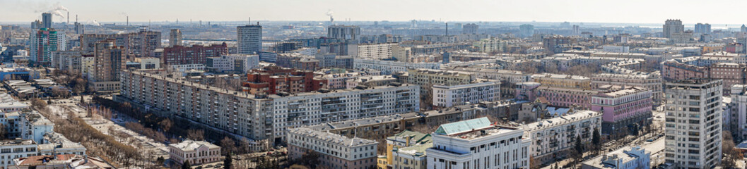 Fototapeta premium Panoramic view from above of the city of Chelyabinsk in Russia Many high-rise buildings of various types are visible, the sky is blue and clear, the weather is cold.
