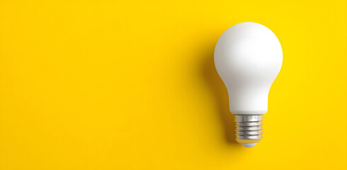 close up of a white light bulb combined on a yellow background representing the concept of idea vision creativity and inspiration