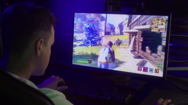 PC gamer displaying skills in the modern computer simulator. PC gamer showing skills by destroying the opponents in a battle royale competition. PC gamer kills enemies with shooting skills.