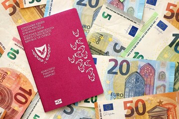 Kyprus passport lies on big amount of euro money banknotes close up. Rich life and travel in Europe concept
