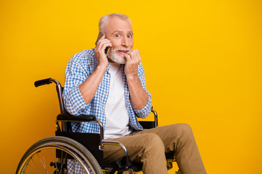 Cheerful grandpa on a sunny day talks on the phone from a wheelchair turning a simple moment into a warm scene of resilience and connection - Powered by Adobe