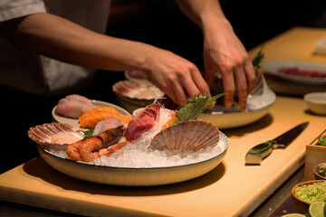 Chef preparing fresh seafood platter with vibrant ingredients and garnishes