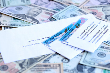 Permanent resident green cards and envelope lies on many dollar bills close up