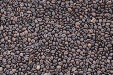Pile of fresh roasted brown coffee beans close up. Food photo for backdrops