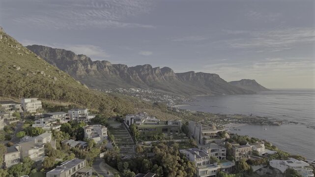 Cape Town drone video from Sea Point at the base of Lions Head flying right toward the ocean to reveal Camps Bay and the coastline