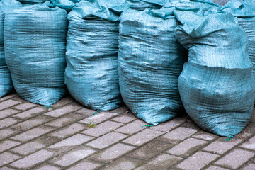 Close-up of several large bags of loose building materials and waste from renovations