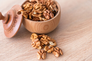 Whole walnuts and split on table. kernels of walnuts are dried and ready to eat. Soft focus. Blured picture.