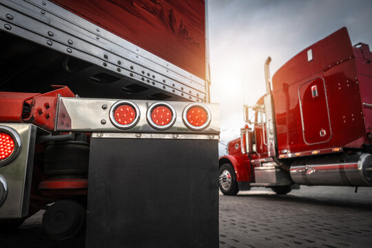 Fototapeta Trucks Parked Under Cloudy Sky at Sunset at Truck Stop