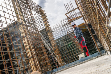 Construction Worker Managing Rebar at a Building Site
