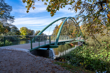 Bridge across Motala Stream connecting city park Åbackarn wirh Folkparken on a sunny autumn day in mid-October 2025 in Norrköping, Sweden