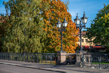Street Kungsgatan on Bridge Bergsbron across Motala Stream during autumn in Norrköping. Norrköping is a historic industrial town in Sweden.