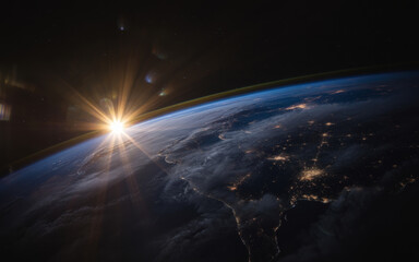 Fototapeta premium Earths horizon with sunrise and clouds from space satellite