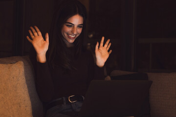 Happy caucasian young girl student watch webinar listen online course communicate by conference video call e learn language in app laugh study with teacher lesson look at laptop at night