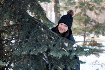 Naklejka premium Portrait Of A Carefree Woman Walking In A Winter Forest