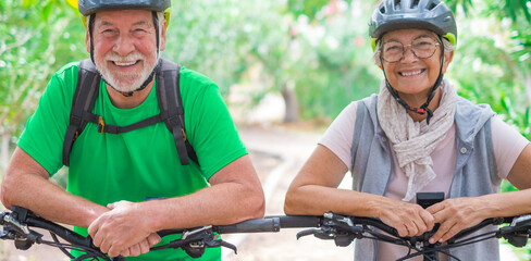 Portrait of couple of old and happy in love seniors looking at the camera smiling and having fun...
