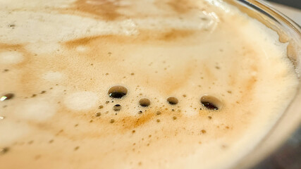 Golden espresso crema bubbles like a caramel sunrise, perfect for International Coffee Day or a cozy Hygge moment