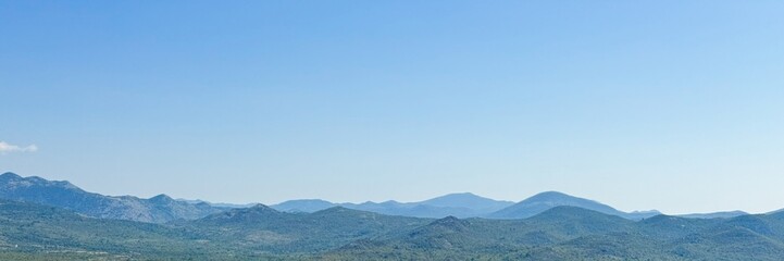 Obraz premium Vast azure sky blankets serene mountain panorama, capturing ethereal whispers of wanderlust, perfect for Mountain Day and Sky Appreciation Week