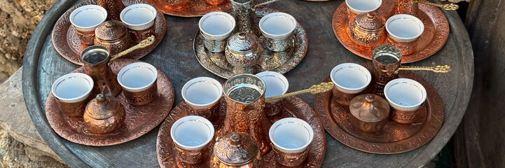 Intricately embossed copper coffee sets dance in sunlight, evoking Turkish delight mornings,...