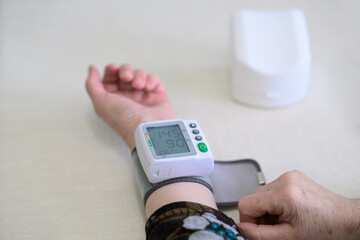 Senior Woman Checking Blood Pressure with Digital Wrist Monitor